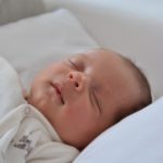 Bébé dort à poing fermé dans son lit